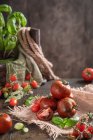 Fresh tomatoes with water drops on a wooden table — Stock Photo