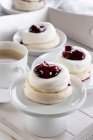 Mini meringues with cream and cherries — Stock Photo
