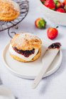 Classic scones with cream and strawberry jam — Stock Photo