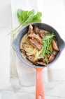 Fried liver with onions and mint in a frying pan — Stock Photo