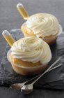 Rum baba with cream in plastic bowls — Stock Photo