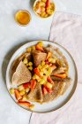 Cinnamon crepes with caramelized apples and strawberries — Stock Photo