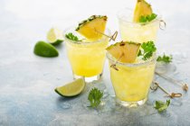 Pineapple margarita cocktails with lime and cilantro — Stock Photo