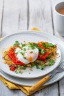Potato rosti with chorizo, coriander, red pepper dip and poached egg — Stock Photo