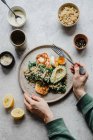 Millet with avocado kale egg and grilled halloumi topped with tahini sauce — Stock Photo