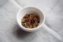 Fennel seeds, coriander seeds, star anise and peppercorns — Stock Photo