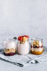 Healthy raspberries parfaits with yogurt in glass jars — Stock Photo