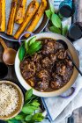 Braised ox tail with rice and pumpkin wedges (top view) — Stock Photo