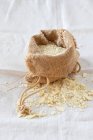 Almond flour in a burlap bag on a linen cloth — Stock Photo