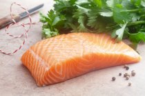 Raw salmon fillet with parsley — Stock Photo