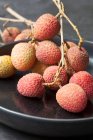 Fresh lychee fruits on wooden background — Stock Photo