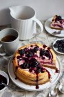 A small blackberry cheesecake, sliced — Stock Photo