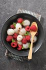 Lychees and raspberries in champagne sauce — Stock Photo