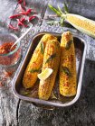 Grilled corn cobs with butter, chilli and fresh sage — Stock Photo
