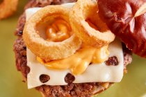 Teriyaki burger with emmental and onion rings — Stock Photo