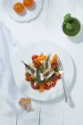 Warm sardines fillets with tomatoes and basil cream on plate — Stock Photo