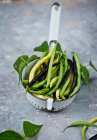 Fresh green and yellow beans in a vintage colander — Stock Photo