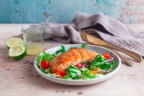 Fried salmon fillet on mixed leaves salad — Stock Photo