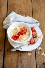 Millet porridge with strawberries and flaked almonds — Stock Photo