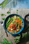 Oriental noodles with chilli jam, beans, herbs and grilled red snapper — Stock Photo