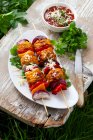 Vegetable skewers topped with grated cheese — Stock Photo