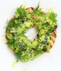 A grilled bagel with avocado cream and dill (close up) — Foto stock