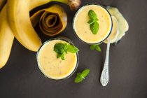 Mango and banana smoothie in glasses — Stock Photo