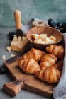 Croissants with hard cheese and grapes — Stock Photo