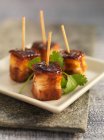 Crispy pork belly cubes on skewers with coriander — Stock Photo