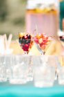 Glasses with different cherries on a garden table — Stock Photo