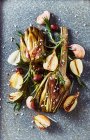 Oven-roasted artichokes with garlic, onions, olives and rosemary — Stock Photo