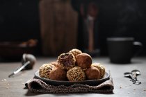 Chocolate truffles with kakao and nuts — Stock Photo