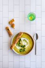 Broccoli soup with olive bread sticks — Stock Photo
