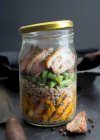 Roasted duck breast with buckwheat, grilled sweet potatoes and green beans in a glass jar — Stock Photo