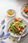 Весенний салат с зеленой спаржей, помидорами, базиликом и фокаччей — стоковое фото