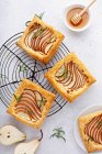 Pear and rosemary puff pastries with honey — Stock Photo
