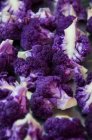 Крупный план нарезанных фиолетовых цветных цветков на сковороде — стоковое фото