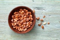 Wild peanuts in a wooden bowl — Stock Photo