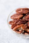 Pecan nuts in a glass bowl — Stock Photo