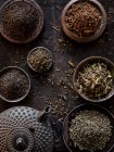 Close-up shot of delicious Different tea leaves with a teapot — Stock Photo