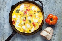 Oven baked tomato and cheese omelet in pan — Stock Photo