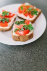Bruschetta topped with cottage cheese and tomatoes — Stock Photo