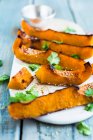 Oven baked pumpkin wedges with miso paste — Stock Photo