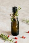Black mini bottle of champagne decorated with rosemary — Stock Photo