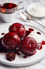 Plums poached in port wine with spices — Stock Photo