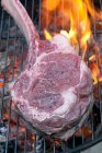Tomahawk steak on charcoal grill — Stock Photo