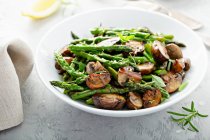 Sauted mushrooms, asparagus, lemon zest and herbs — Stock Photo