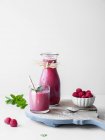 Rosafarbener Lakritze und Himbeer-Smoothie im Glas und in der Karaffe — Stockfoto