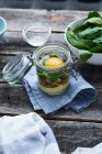 An egg in a glass: layered ingredients in a flip-top glass jar — Stock Photo