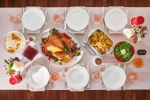 Set table with roast turkey and side dishes — Stock Photo